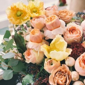 A beautiful floral bouquet featuring roses and poppies, perfect for weddings or celebrations.